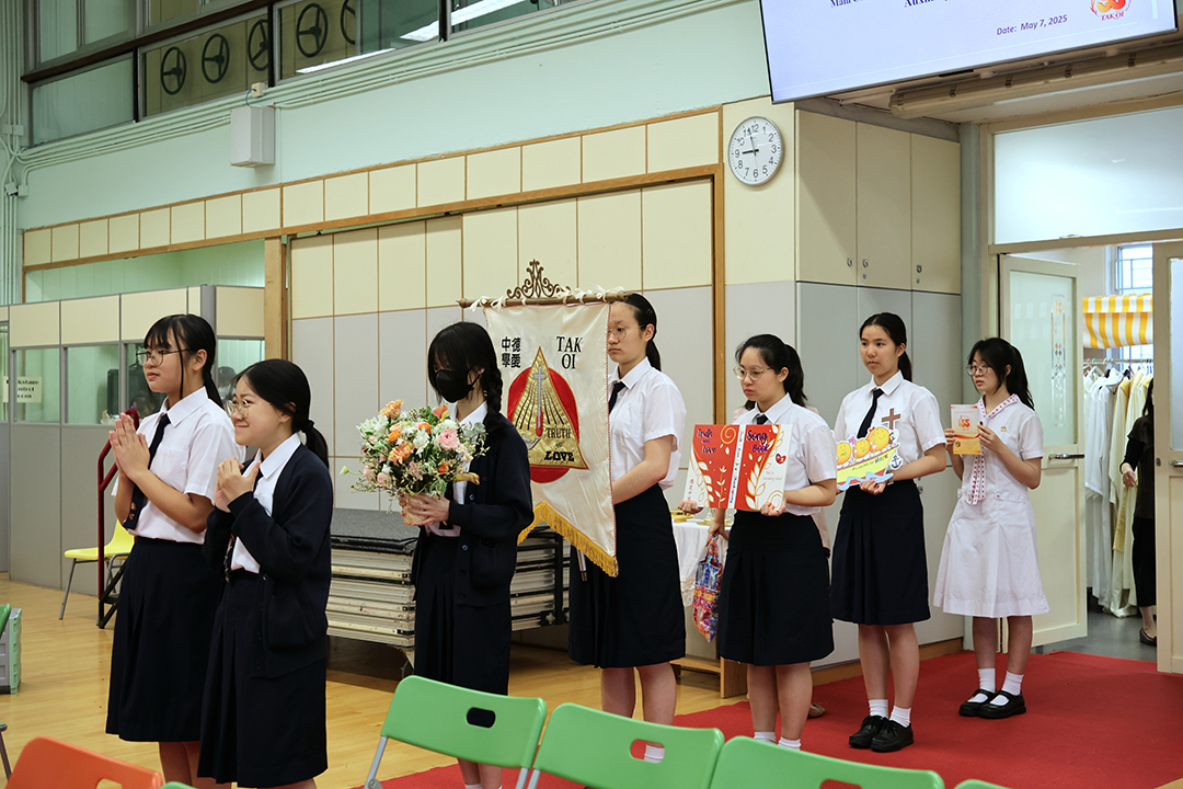 A group of girls wearing masks and standing in front of a statueDescription automatically generated